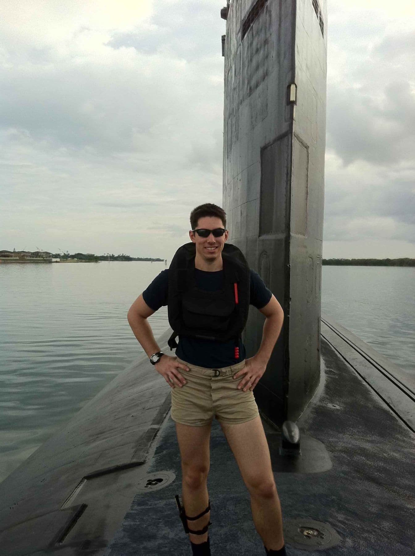 Aaron as a Navy diver standing on a submarine